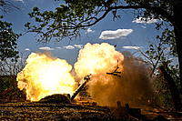Soldiers from the artillery crew of the Striletskyi Special Forces Police Battalion of the Main Department of the National Police in the Zaporizhzhia region fire a 122-mm howitzer D-30 at the positions of Russian troops in the Zaporizhzhia region, Ukraine, on May 23, 2025. 