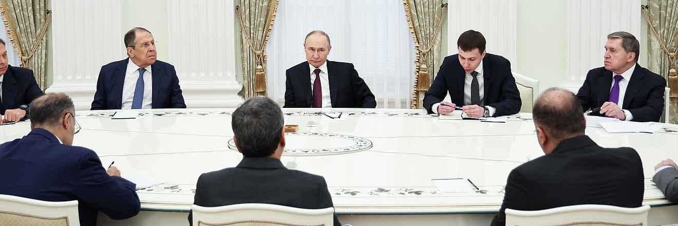 Vladimir Putin (C), President of Russia, attends a meeting with Abbas Araghchi, Foreign Minister of Iran, at the Moscow Kremlin.