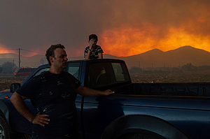 Local residents watch the wildfire in Avantas village, near Alexandroupolis town, in the northeastern Evros region, Greece, Aug. 21, 2023.