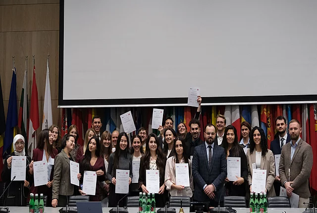 A group photo of the OSCE Youth Event shows the participants
