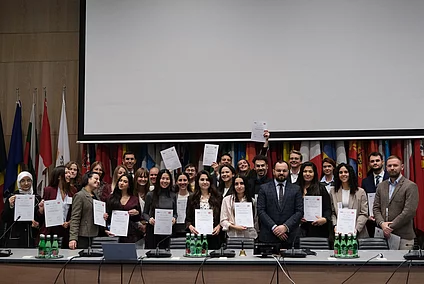 A group photo of the OSCE Youth Event shows the participants